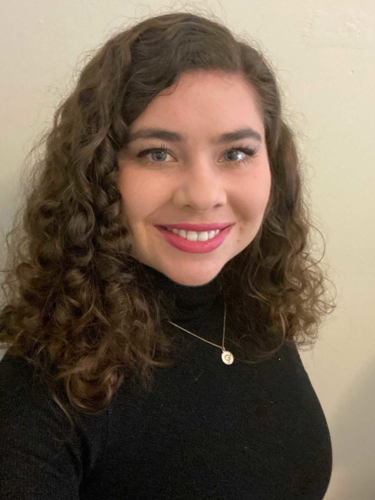 A dark-haired woman smiling.